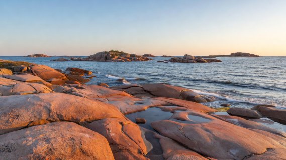 Smooth red rapakivi granite island coastline in the Åland archipelago